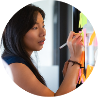 Employee analyzing chaotic notes on whiteboard