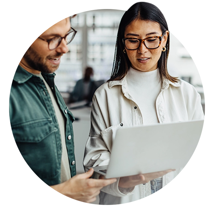 Two team members smiling and collaborating