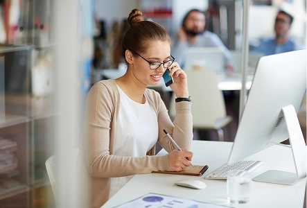 Vendor manager smiling while speaking on phone with vendor